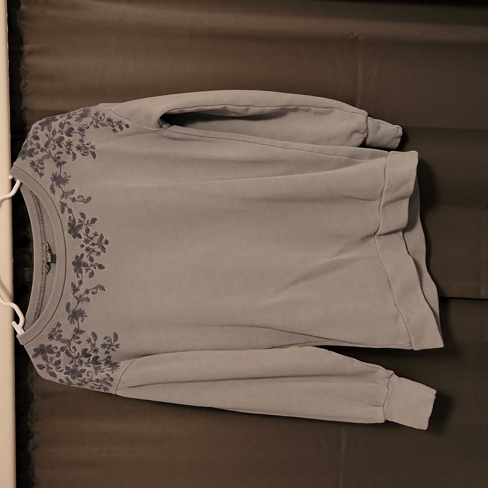 Light sweater, blue with flowers along the neck.